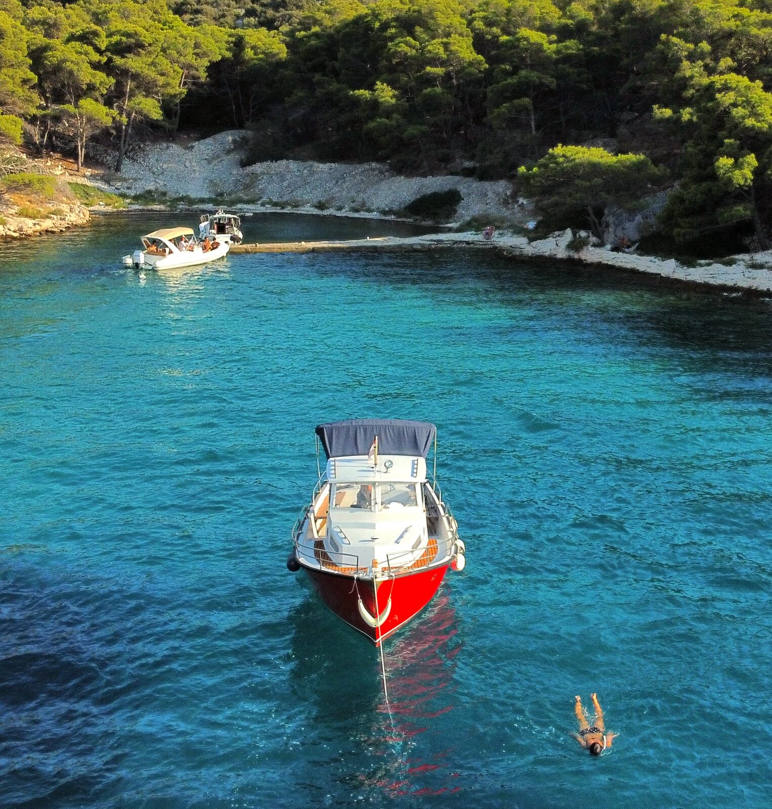 Quiet bay with anchored boat at golden hour